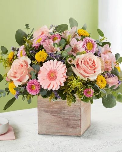 Spring is a time to refresh and reach out. Our spring bouquet celebrates that sentiment. Soft pink and yellow blooms are loosely gathered with lush greenery for style and texture. Designed in our rustic, grey-washed wooden cube, it’s a gift that delivers on your feelings in the most beautiful way.