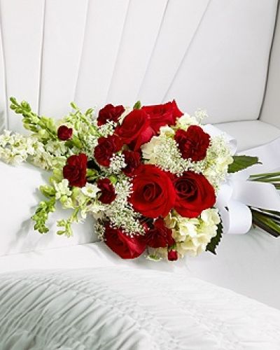 <p>The FTD® Forever in Our Hearts™ Casket Adornment is a beautiful accent piece that adds that extra touch of elegance to their final farewell service. Red roses and mini carnations are eye-catching and bright arranged amongst white hydrangea, larkspur, snapdragons and Queen Anne's Lace. Tied together with a white grosgrain ribbon, this gorgeous bouquet is a lovely way to say goodbye to your beloved.</p>