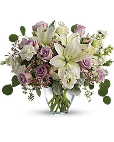 <div id="mark-2" class="m-pdp-tabs-marketing-description">Luxe in love! Pale lavender roses, creamy white lilies and delicate greens create a soft sweet bouquet that's as tender as your feelings.</div>
<div id="desc-2">
<ul>
 	<li>Lavender roses, white asiatic lilies, white lisianthus, white stock, lavender waxflower, and white sinuata statice are accented with dusty miller, seeded eucalyptus, and silver dollar eucalyptus.</li>
 	<li>Delivered in a serenity vase.</li>
</ul>
</div>