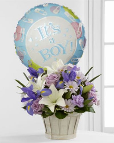 The FTD® Boys Are Best!™ Bouquet is blooming with sweet love to congratulate the new family on their darling baby boy! Lavender roses, blue iris, lavender carnations, lavender daisies, white Asiatic lilies and lush greens are beautifully arranged in a round whitewash woodchip basket. Presented with a Mylar balloon declaring, “It’s a Boy!” this incredible flower arrangement is the perfect welcome for their new addition.