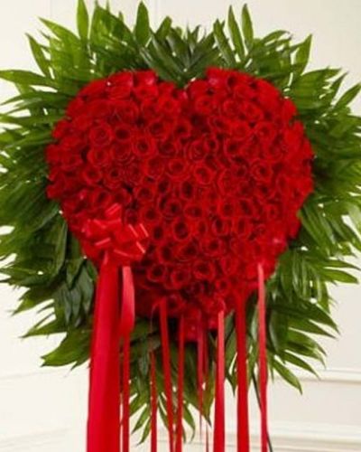 When words aren't enough to express the depths of your love, this heart-shaped arrangement makes an unforgettable statement and stunning tribute. This standing spray arrangement is expertly crafted from fresh red roses. Traditionally delivered directly to the funeral home.