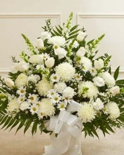 <p>Crafted from striking white blooms, our tasteful floor basket arrangement is a beautiful symbol of your care and concern in this time of sorrow. Hand-gathered with the freshest roses, mums, snapdragons and more, it's a beautiful expression of your sentiments as well as a touching way to remember a loved one who has passed. Appropriate for family, friends or business associates to send directly to the funeral home.</p>