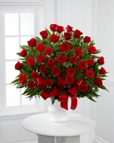 <p>Each rose in our Blessed with Love™ is a touching way to share your expressions of sympathy for a cherished loved one. Accented by a collection of luscious greens, the red blooms are carefully placed by a local florist and delivered right to the service.</p>