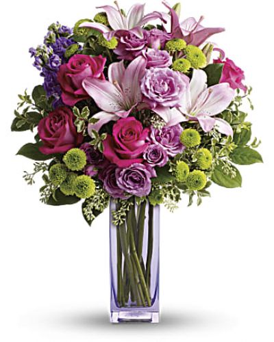 No one can resist the beauty of this bright bouquet! A sublime way to celebrate any occasion, this special delivery blends hot pink and lavender roses with pink lilies and lime green button mums for a look that's pure heaven. It's all artfully arranged in our exclusive, lovely lavender glass vase they'll always treasure.