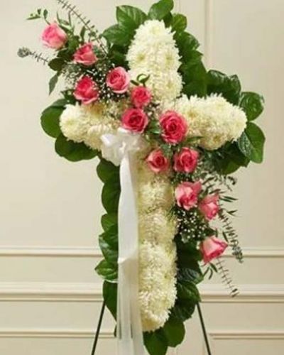 <p>This beautiful floral tribute shows your faith, hope and love during this difficult time. The standing spray arrangement in the shape of a cross is created from fresh white mums, pink roses, spiral eucalyptus and more. Traditionally sent directly to the funeral home by family members or friends and displayed on a stand.</p>
