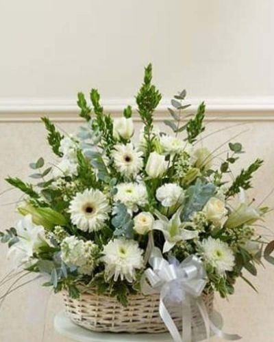 Send an expression of your sympathy and compassion with this sophisticated and elegant arrangement of white roses, hybrid lilies, Gerbera daisies and more. Appropriate for friends, family and business associates to send directly to the funeral home or to the family's home.