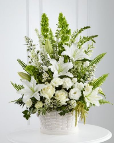 <p>The FTD® In Our Thoughts™ Arrangement is a symbol of pure peace and caring kindness. White roses, tulips, freesia, Oriental lilies, double lisianthus, monte casino asters, and snapdragons, are beautifully offset by bright green Bells of Ireland, ivy vines, and an assortment of lush greens to create an elegant display that conveys your deepest sympathies for their loss. Arrives in a large round whitewash basket.</p>