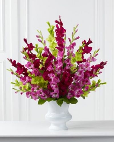 <p>The FTD® Solemn Offering™ Arrangement is a bright and beautiful way to say your final farewell. Fuchsia, magenta and jade gladiolus are accented with lush greens and displayed in a white plastic urn to commemorate the life of the deceased with fantastic color and elegance.</p>