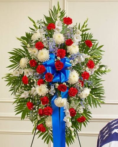 <p>Honor a beloved veteran for their dedicated service with this heartfelt patriotic arrangement. Meticulously crafted by our expert florists using the freshest red, white and blue blooms, it perfectly conveys all the love, pride and sympathy you feel in your heart. This standing spray arrangement features fresh red, white and blue flowers such as roses, football mums, gladiolas, delphiniums, carnations and more. Appropriate for family, friends and business associates to send directly to the funeral home.</p>