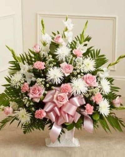The Touching Tribute Floor Basket is a meaningful way to express your care and concern. With pink flowers to symbolize admiration and appreciation for a life well lived and white flowers to symbolize peace and respect, this gathering of fresh pink roses, white spider mums, white snapdragons, pink carnations and more delivers beauty and hope to a difficult time. Appropriate for family, friends or business associates to send directly to the funeral home.