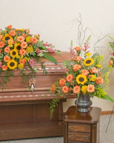 <p>Includes a casket spray, standing spray and urn design in the warm colors of a sunset.</p>