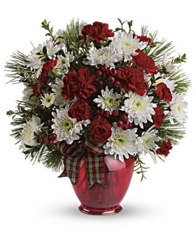 <p>A joy to give and receive, this very merry arrangement delights with fresh flowers, winter greens and red berries in our charming red ginger jar vase.</p>