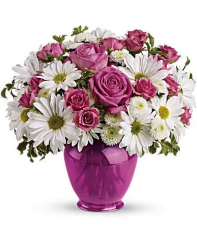 Make their spirits soar with a surprise bouquet of pink roses and white daisies in a dazzling fuchsia ginger jar. This classic vase, is not only beautiful, but beautifully affordable. They'll love it for years.
The lush bouquet includes pink roses, pink spray roses, white daisy spray chrysanthemums and white button spray chrysanthemums accented with fresh greenery.