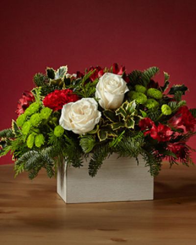 <p>Dress the tablescape in winter wanderlust with our Snow Ball Bouquet and add an air of sophistication with the elegance of white roses. The holly lays over a white wooden box, perfect for a tasteful holiday gathering.</p>