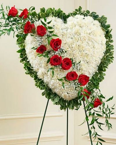 <p>This beautiful floral tribute shows your undying love during this difficult time. This standing spray arrangement in the shape of a heart is created from fresh white carnations, red roses, baby's breath and more. Traditionally sent directly to the funeral home by family members or friends and displayed on a stand.</p>
