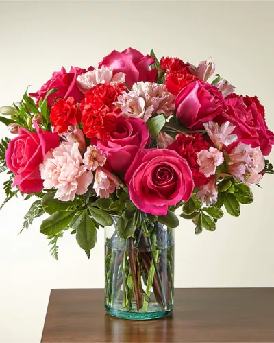 <p>Blushing shades of pink blooms are nestled in lush greens to charm anyone's day. This bouquet is abundant with a classic assortment of pretty florals – roses, alstroemeria and carnations to name a few.</p>