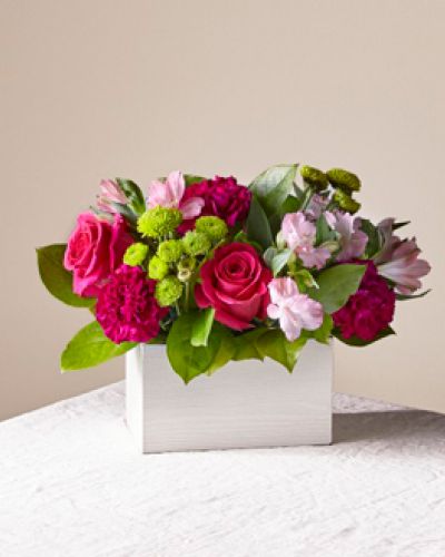 <strong>Bright pink blooms mingle among an assortment of lush greenery to create Watermelon Punch. As the weather warms up, give this vibrant floral arrangement to brighten up a friend's home, say thank you or simply celebrate the season.</strong>