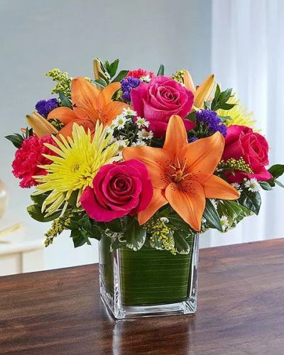 <p>Send a beautiful expression of your sympathy with this cube vase arrangement. This bouquet features bright-toned blooms such as roses, lilies, spider mums, carnations, solidago, statice and monte casino accented with variegated pittosporum and myrtle. Appropriate for the service or for sending to the home or office of friends and family members.</p>