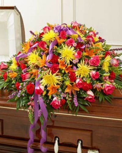 <p>Send an elegant expression of your love and a touching tribute to a loved one with this bright casket cover arrangement. Features gorgeous bright blooms such as long-stem roses, lilies, spider mums, larkspur, carnations, monte casino and more. Traditionally sent by the immediate family to the funeral home.</p>