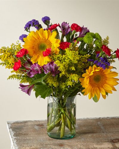 Summer in the Cape has all the seasons’ favorites like sunflowers, alstromerias, button pompoms and more. Crafted by an expert florist, this arrangement has bold and beautiful colors that remind you of warm days and spending time with the ones you love.