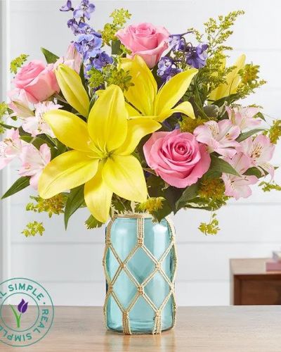 <p>Celebrate spring with garden-meets-coastal style. Our loosely gathered bouquet is designed exclusively in partnership with Real Simple, and features a bright mix of blooms. Arranged in our sea green jar inspired by repurposed glass, with an eco-friendly, handmade macramé cover, this gift brings beachy, Boho charm into homes everywhere.</p>