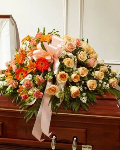<p>Send the perfect expression of your love and a tribute to a beautiful life. This arrangement features gorgeous long stem peach roses, orange Asiatic lilies, white snapdragons and more. Traditionally sent by the immediate family to the funeral home.</p>