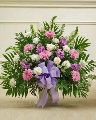 <p>This delicate floor basket arrangement helps you convey your care and concern with beautiful lavender flowers to represent a vibrant life and fresh white blooms to symbolize purity and peace. This arrangement features fresh white roses, snapdragons, carnations, lavender mums, lavender stock and more. Appropriate for family, friends or business associates to send directly to the funeral home.</p>