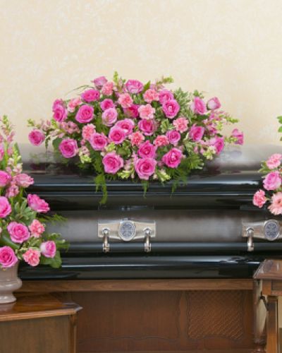 Casket spray, standing spray and urn design in peaceful pink colors.